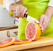 Photo: Woman's hands cutting grapefruit Woman's hands cutting grapefruit