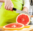Photo: Woman's hands cutting grapefruit Woman's hands cutting grapefruit