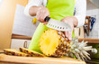 Photo: Woman's hands cutting pineapple Woman's hands cutting pineapple