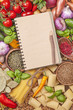 Foto: Assortment of fresh vegetables and recipe book Assortment of fresh vegetables and recipe book