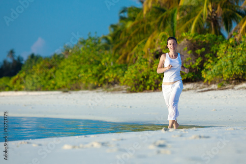 Photo: Caucasian woman jogging at seashore Caucasian woman jogging at seashore
