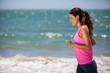 Photo : Young woman running at the beach Young woman running at the beach