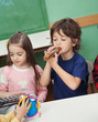 Children Playing Musical Instruments In Classroom