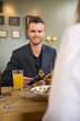 Young Businessman Having Food With Female Colleague