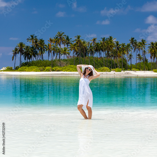 Photo: Caucasian woman rests at beautiful seashore Caucasian woman rests at beautiful seashore