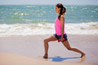 Cute girl exercising at the beach