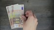 Hand counts money
