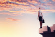 Businesswoman on top of building