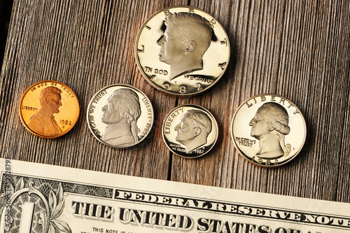 Photo: US money over wooden background US money over wooden background