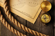 Photo: Antique compass and rope over old map Antique compass and rope over old map