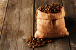 Photo: Coffee beans in bag on table Coffee beans in bag on table