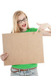 Happy young girl holds up  empty wooden notice board.