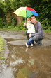 girl with an umbrella in the rain with his father