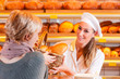 Salesperson with female customer in bakery