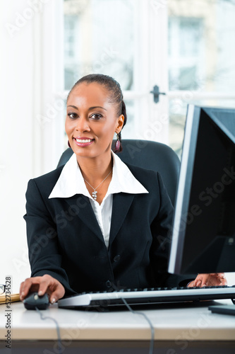 Photo: Lawyer in office sitting on the computer Lawyer in office sitting on the computer