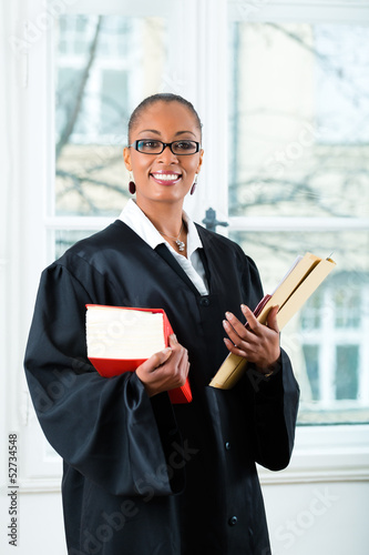 Photo: Lawyer in office with law book and Dossier Lawyer in office with law book and Dossier