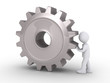 Businessman pushing cogwheel