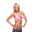 A woman with a big smile on her face measuring her waist