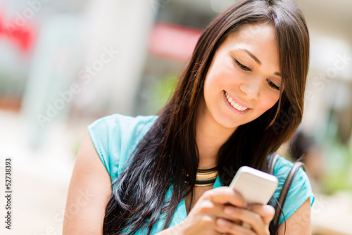 Photo: Woman sending a text message Woman sending a text message