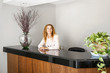 Photo: Smiling woman at office reception Smiling woman at office reception