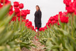 Woman standing in a field of tulips