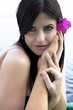 Portrait of beautiful woman with flower and hand of lover
