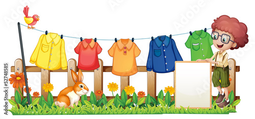 Vector: A boy holding an empty frame in front of the hanging clothes A boy holding an empty frame in front of the hanging clothes