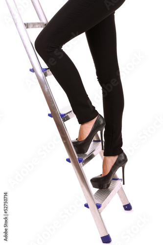Photo: Woman climbing up ladder isolated on white Woman climbing up ladder isolated on white
