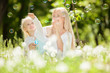Photo: Happy mother and daughter blowing bubbles in the park Happy mother and daughter blowing bubbles in the park