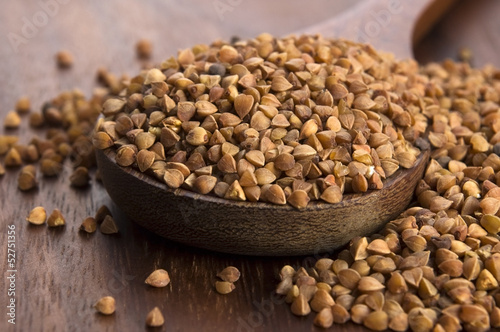 Photo: Buckwheat seeds on wooden spoon in closeup Buckwheat seeds on wooden spoon in closeup