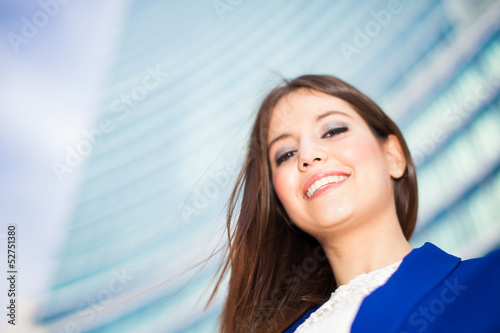 Photo: Businesswoman in front of a skyscraper Businesswoman in front of a skyscraper