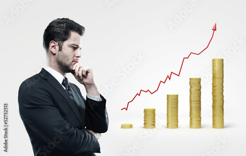 Photo: man looking on coins chart man looking on coins chart