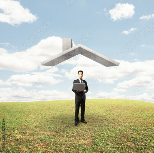 Photo: man standing under house roof man standing under house roof