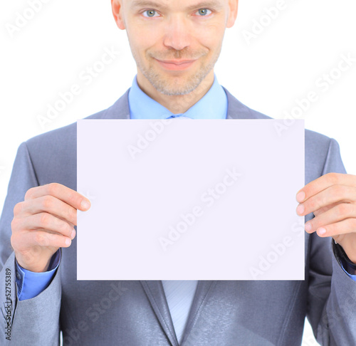 Photo: Nice businessman holds white poster. Nice businessman holds white poster.