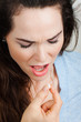 Close-up of a woman with illness taking pill