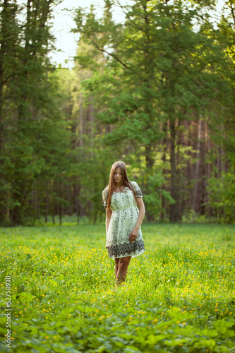 Photo: Beautiful girl among the wild flowers Beautiful girl among the wild flowers