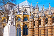 Statue of George V and Westminster Abbey, London