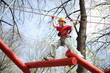 Photo: climber skilfully go on suspension bridge in high ropes course. climber skilfully go on suspension bridge in high ropes course.