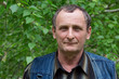 Elderly man with a smile on his face on the nature.