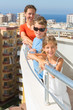 Family of three on balcony of room at hotel on top floor