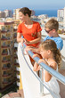 Family on the balcony of room at hotel look down