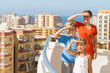 Family on balcony of room at hotel looking into distance