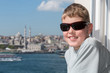 Smiling boy in sunglasses against landscape with river