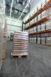 Sacks on wooden pallet inside storehouse
