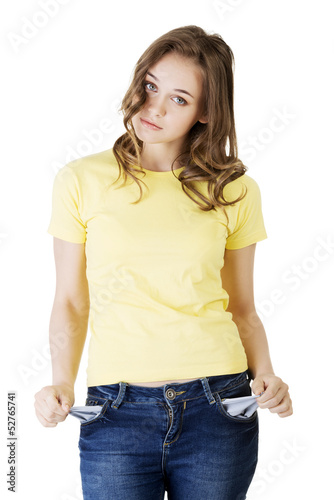 Photo: Sad young caucasian teen girl taking out empty pockets Sad young caucasian teen girl taking out empty pockets