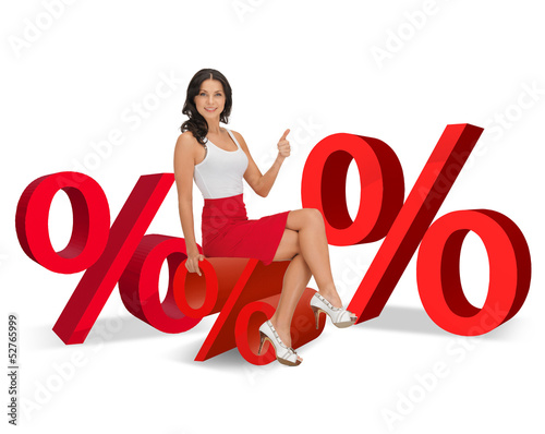 Photo: woman sitting on big red percent sign woman sitting on big red percent sign
