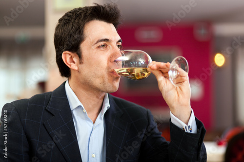 Photo: Man drinking wine at the restaurant Man drinking wine at the restaurant