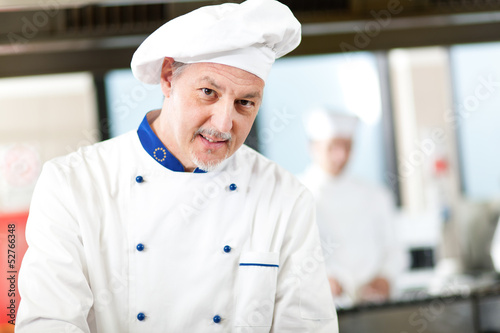 Photo: Mature chef in his kitchen Mature chef in his kitchen