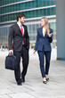 Portrait of businesspeople walking and talking 
