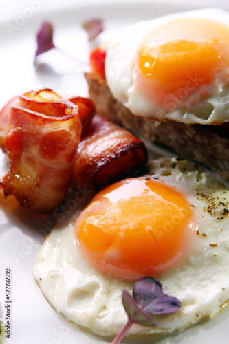 Photo: Scrambled eggs served with bacon and green Scrambled eggs served with bacon and green